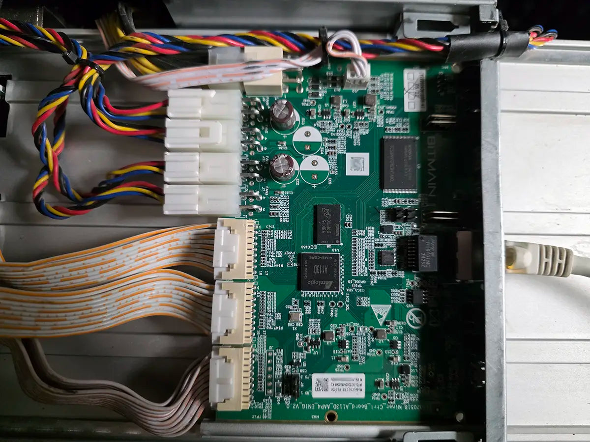 Antminer S21 Amlogic A113D control board seen from above, with the quad-core A113D processor, memory chips, the three hashboard ribbon headers and the BITMAIN silkscreen