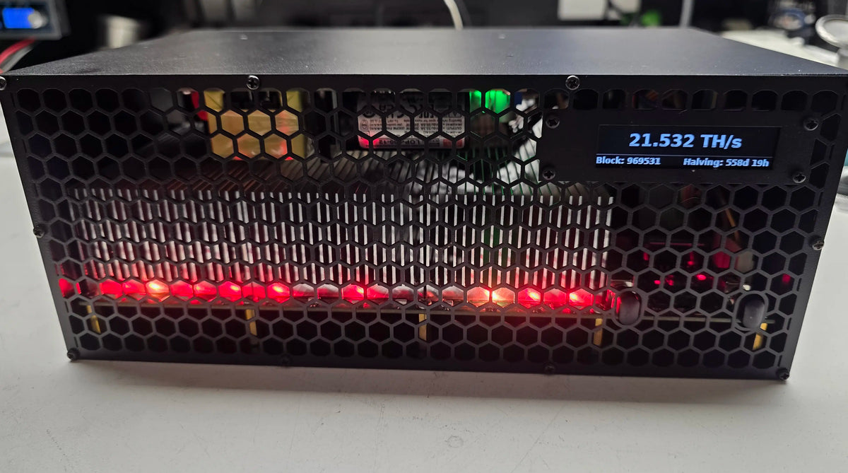 GekkoScience KBox running on the repair bench, front stats screen reading 21.532 TH/s with block height and halving countdown